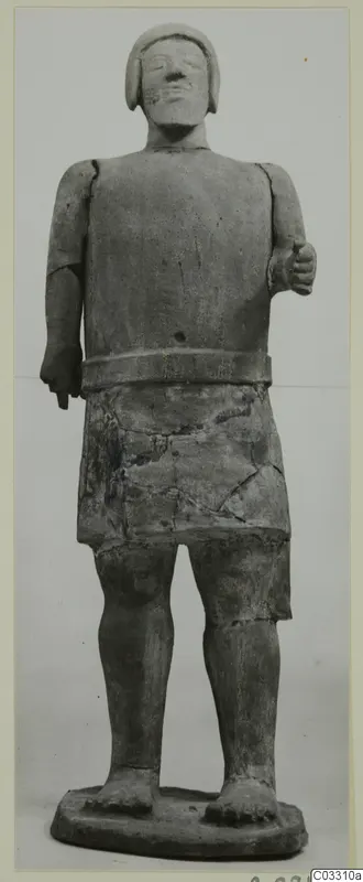 Terracotta Proto-Cypriote I, standing figure with a close-fitting head covering, a waist band over a short skirt, and one hand raised