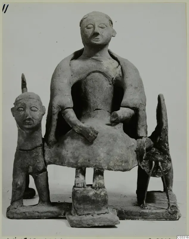 Terracotta group of a seated figure on a block-shaped seat, with a small standing figure and a four-legged animal beside it