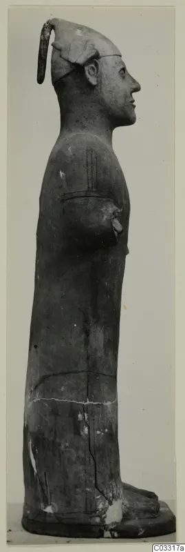 Standing terracotta statue in side profile, arm bent across the chest, on a flat base, Terracotta Proto-Cypriote II