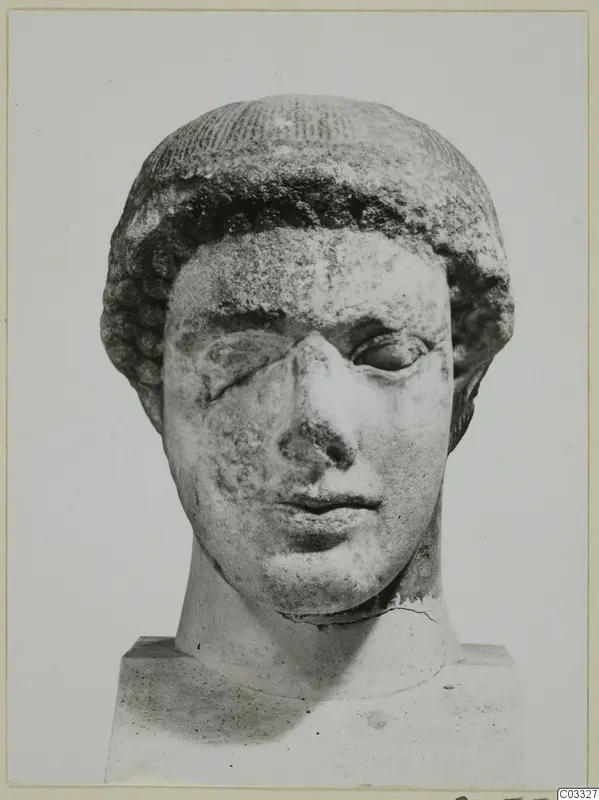 Marble head of a figure with curled hair, nose broken and one eye damaged, on a square base