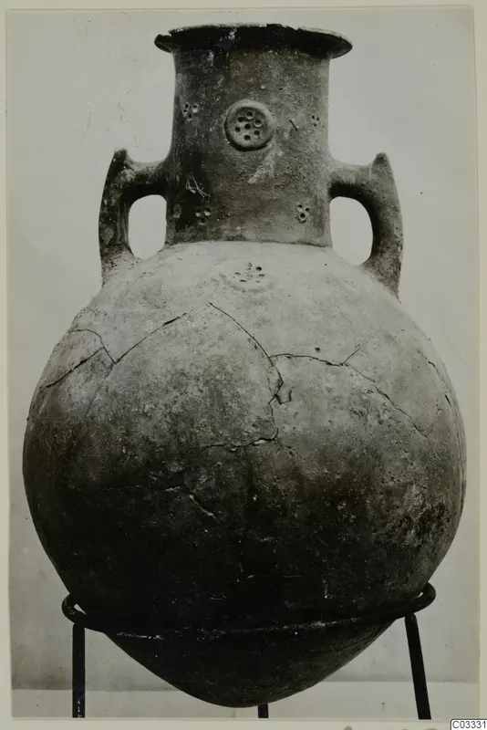Red Polished III amphora from the Vrysi tou Barba tombs at Lapithos, two handles and a flared neck, on a metal stand