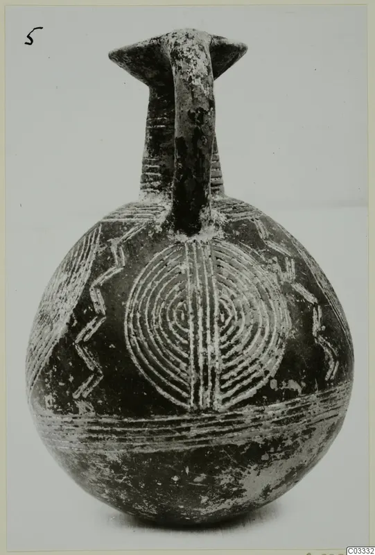 Jug with a strap handle and pale incised concentric-circle and zigzag decoration on a dark surface, from Lapithos