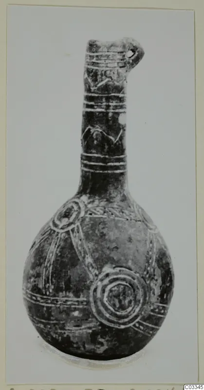 Dark polished pottery vessel with a long neck and round body, decorated with light bands and concentric circles