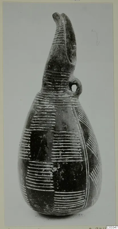 Red Polished III jug with a tall lipped spout, loop handle and light incised banding on the body