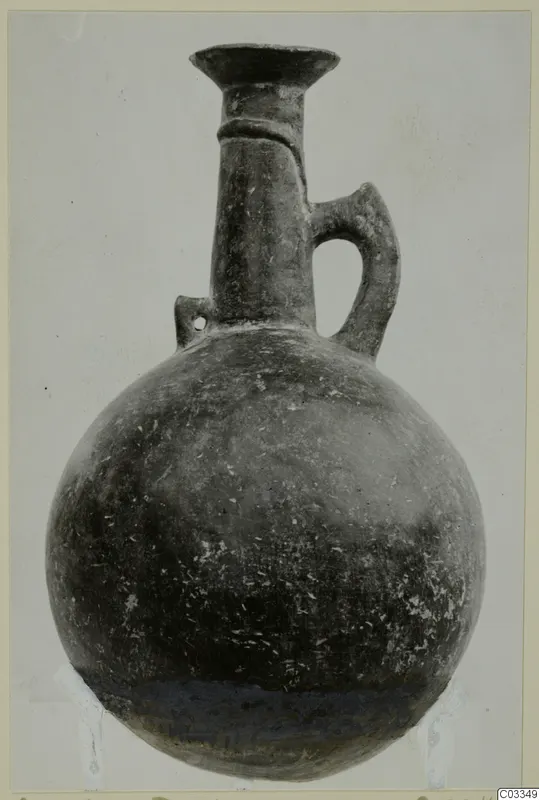Pottery Red Polished III jug with a rounded body, tall flared neck and strap handle