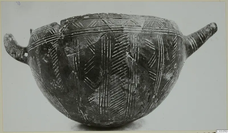 Red Polished III bowl with a loop handle on the left, a tubular handle on the right and incised linear decoration