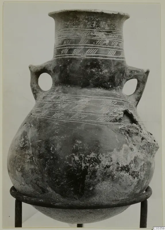 Red Polished III amphora with two loop handles and incised hatched bands, shown on a metal ring stand