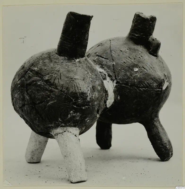 Two pottery vessels with tall necks and three short legs each, from the Vrysi tou Barba tombs at Lapithos