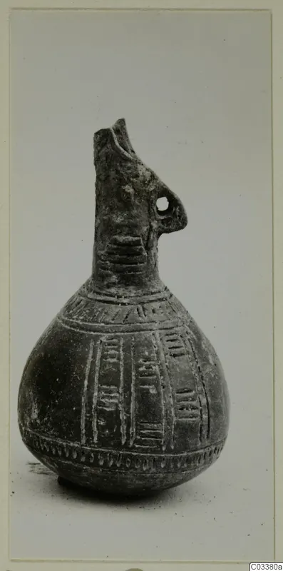 Red Polished III jug from Lapithos, Vrysi tou Barba tombs, with incised bands and a small pierced handle