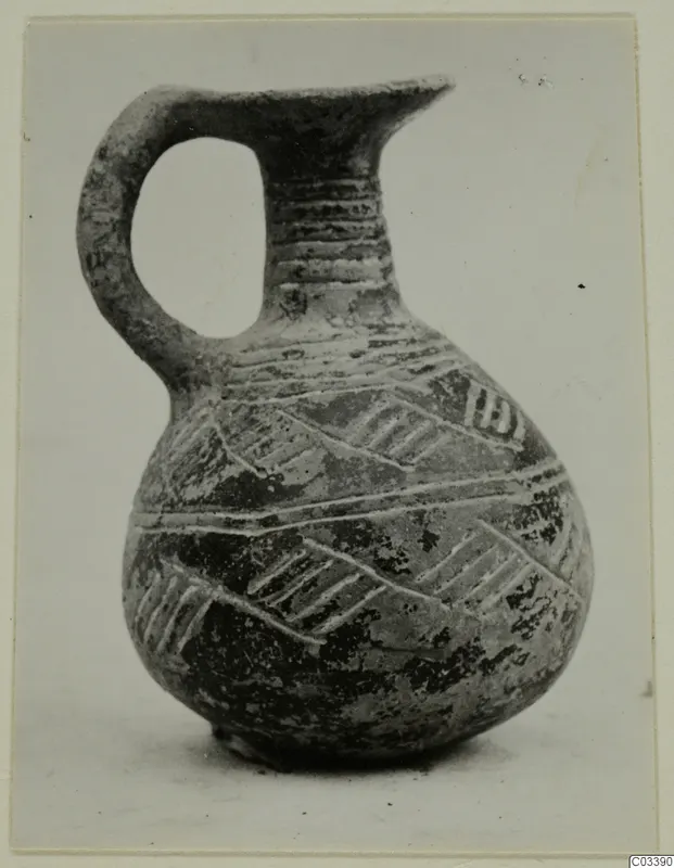Pottery Red Polished II jug from Lapithos, with a loop handle and incised bands of hatched decoration