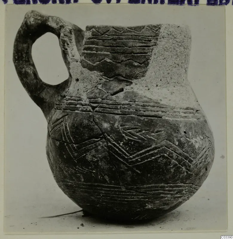 Pottery jug with a loop handle and incised bands and chevron patterns, from Lapithos