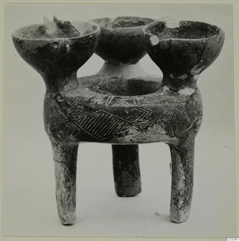 Tripod pottery vessel with three cup-shaped openings and incised chevron and hatched triangle decoration on its body