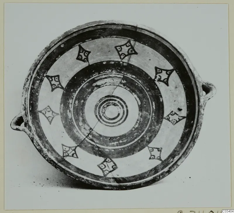 Bowl-jar from Enkomi seen from above, with two small loop handles, concentric painted rings and a ring of dark diamond-shaped motifs.