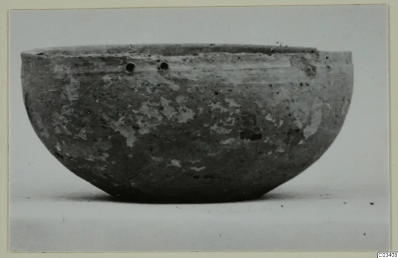 Plain white wheel-made bowl from Enkomi, shown from the side against a pale background.