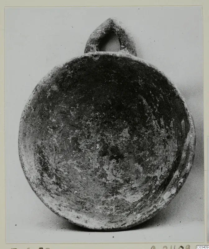 Plain white hand-made ware bowl with a loop handle, from Enkomi