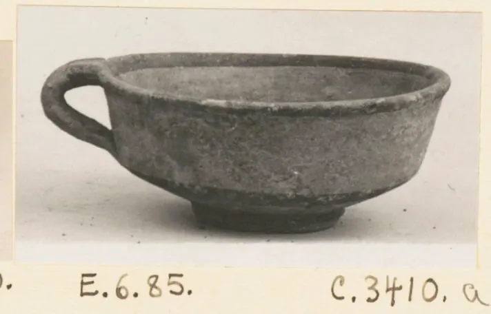 Bowl-jar with a single loop handle, shown in side view on a plain background