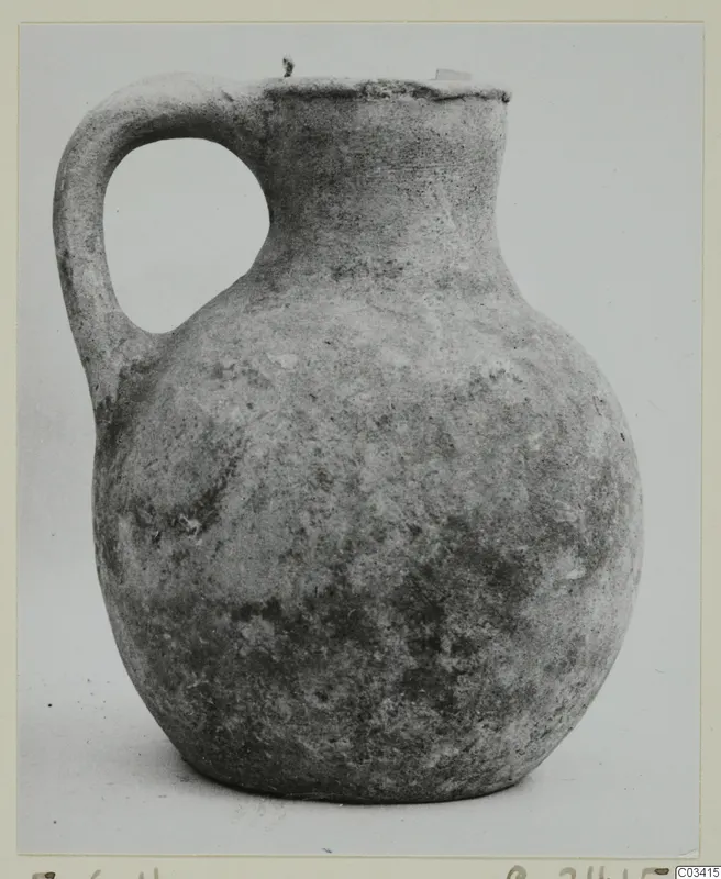 Round-bodied jug with a loop handle and a wide mouth, photographed against a plain background.