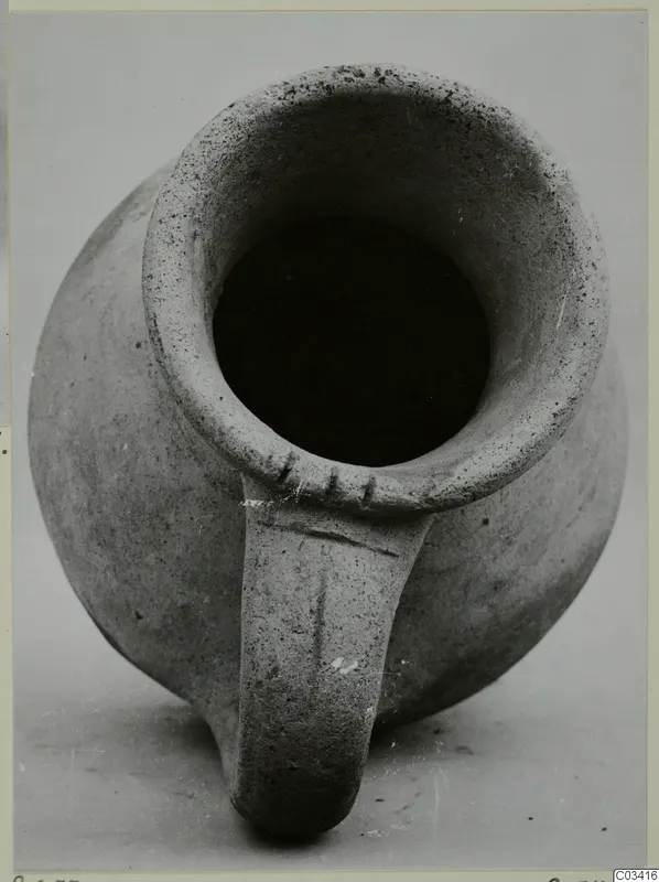 Pottery Plain White Wheel-made vessel with a single strap handle, seen from above