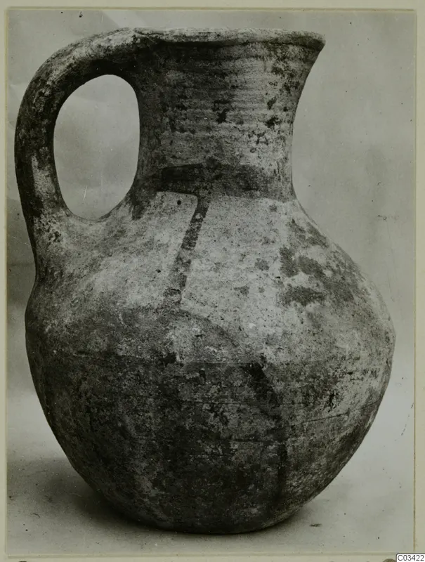 Wheel-made pottery jug with a single loop handle and dark painted bands, from Enkomi