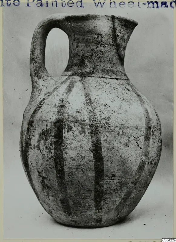 White Painted Wheel-made jug with a strap handle and dark vertical bands on its body, from Enkomi