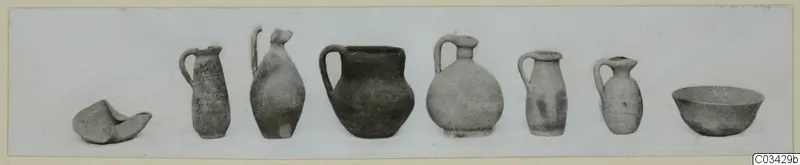 Row of eight pottery vessels from Kountoura Trachonia, Tomb 7, set out on a pale ground