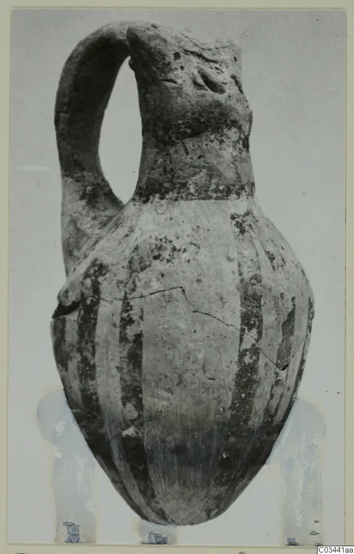 White Painted IV-V pottery jug with a strap handle and dark vertical bands on the body