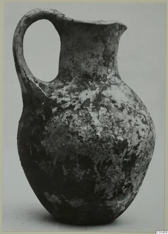Black Slip Ware jug with a single loop handle and a flaring rim, from Enkomi.