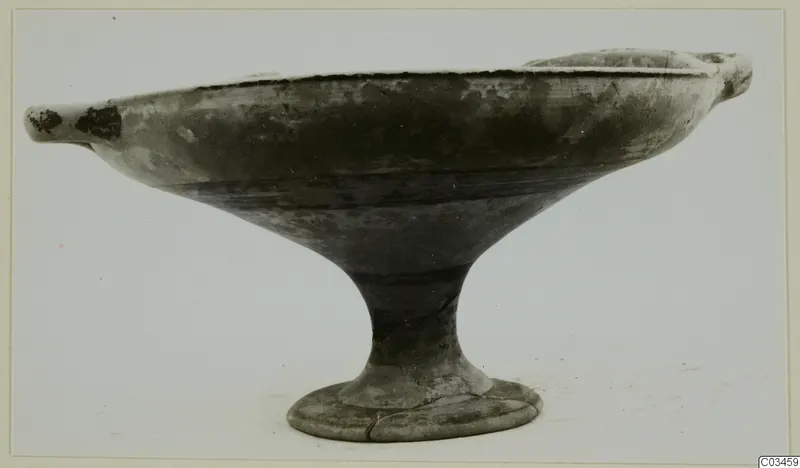 Pottery bowl-jar on a stem foot, with two small handles at the rim, shown against a light background.