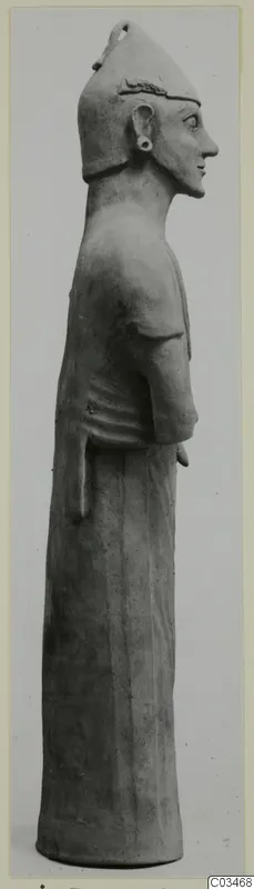 Terracotta standing figure in profile facing right, wearing a tall pointed headdress, from Ayia Irini