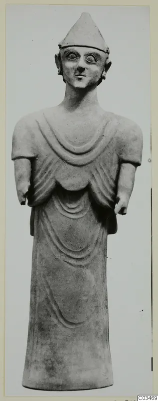 Terracotta Proto-Cypriote I, a standing figure with a conical cap, large round eyes and a long robe