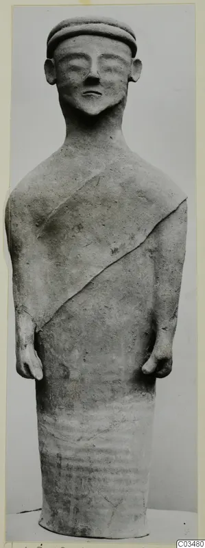 Terracotta standing figure from Ayia Irini, seen from the front against a grey backdrop