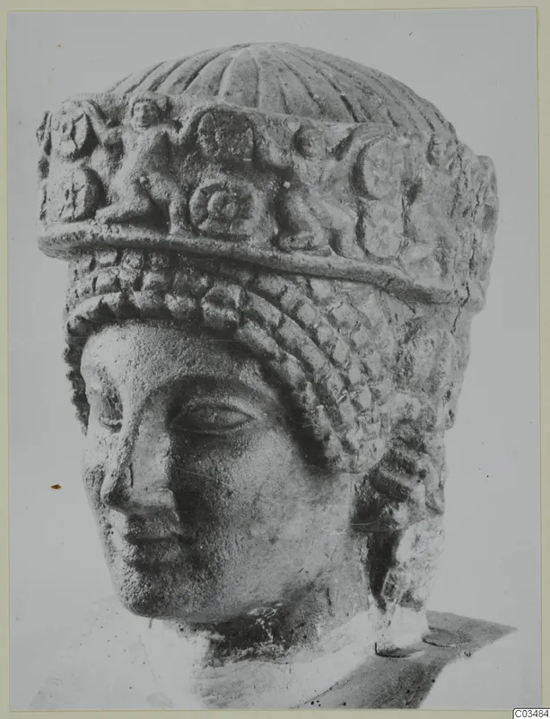 Limestone head of a statue from Arsos, wearing a tall carved headdress with a fluted top and braided hair