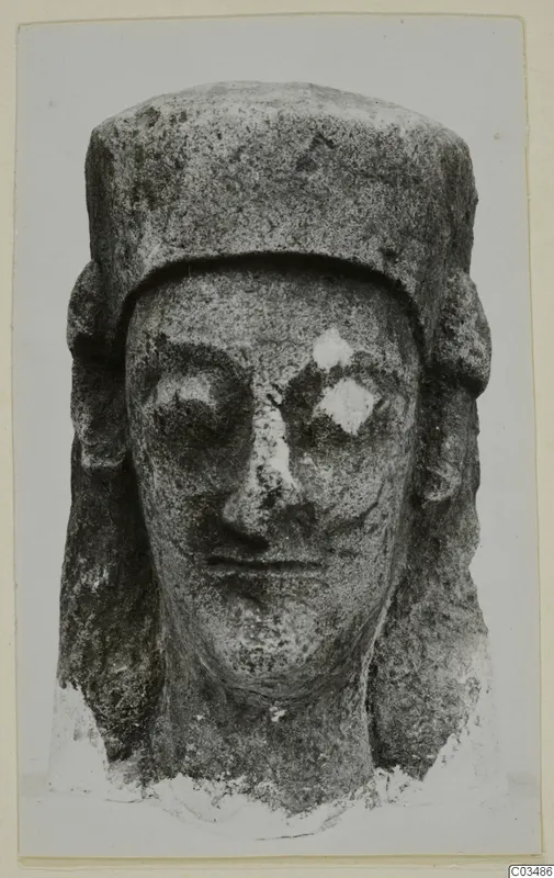 Limestone head sculpture seen from the front, with a flat-topped headdress and side locks