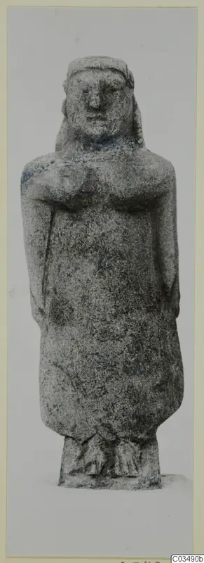 Standing limestone figure, catalogued as Neo-Cypriote, shown frontally against a plain grey background