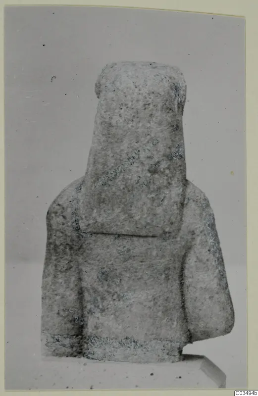 Limestone Neo-Cypriote statue of a block-like figure with a squared head and shoulders, seen from the front.