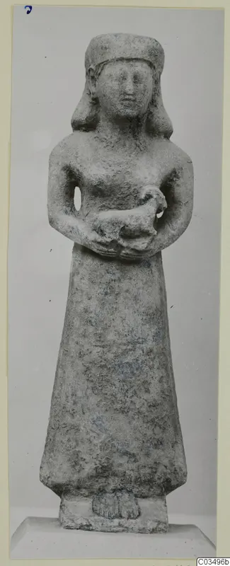 Limestone Neo-Cypriote statue of a standing female figure holding a small animal against her chest