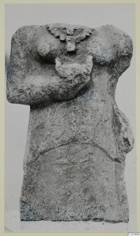 Limestone sculpture fragment of a headless human torso with the arms bent across the chest