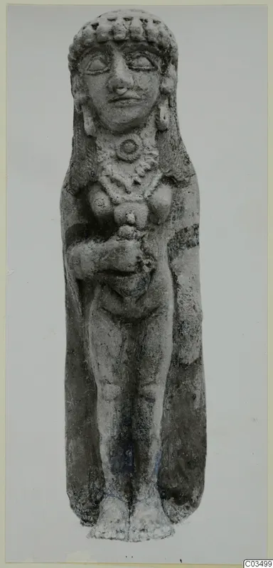 Standing terracotta figurine of a female figure with a tall headdress, necklace and arms bent at the chest.