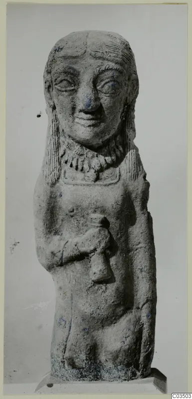 Terracotta figure of a standing figure with long hair, a necklace and one arm bent across the chest