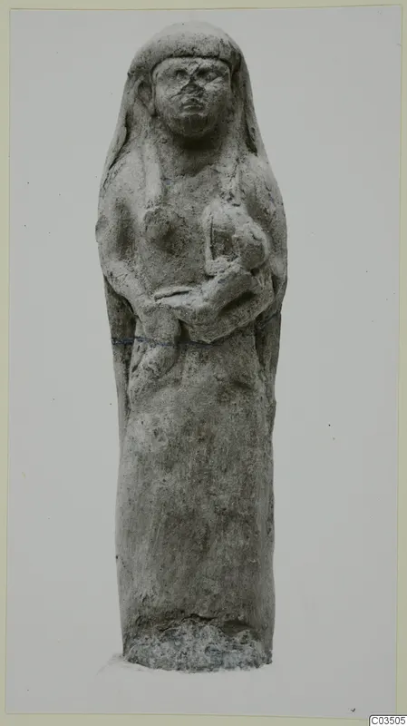 Terracotta figurine of a standing female figure, hands held at the chest, on a rough base