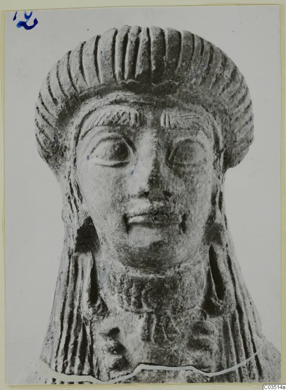 Terracotta head of a figure with ridged hair, seen from the front