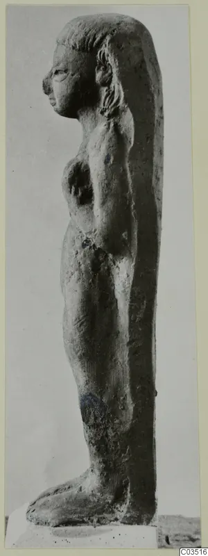 Terracotta figurine of a standing nude female figure, shown in profile facing left