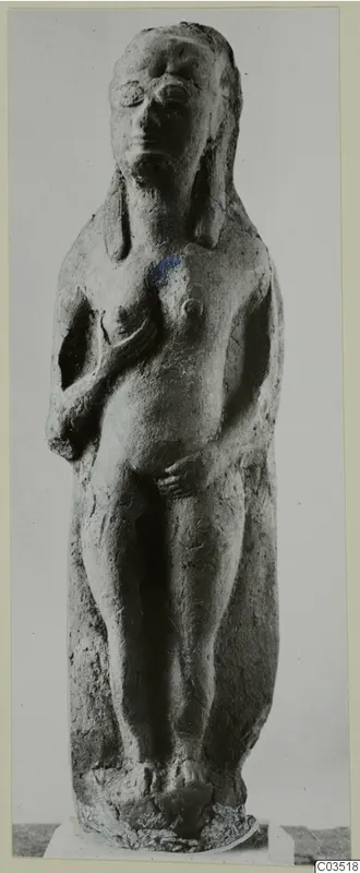 Terracotta figurine of a standing nude female figure, hands raised to the chest and lower body