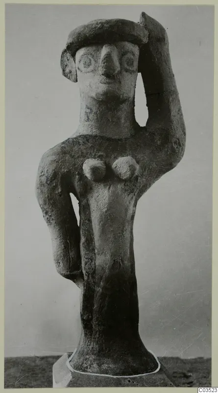 Terracotta figurine of a standing human figure with one arm raised to its head