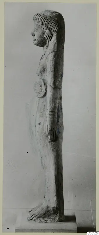 Side view of a standing terracotta figurine on a rectangular base