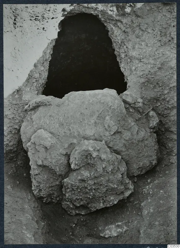 Excavated opening in a rock or earth face at Stylli, with large stones fallen in front of it