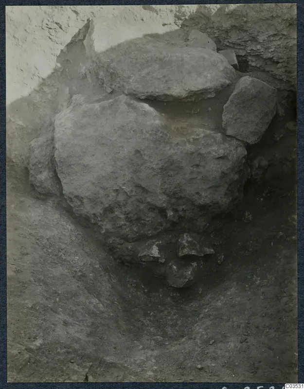 Excavation trench at Stylli with large fallen stones lying in the soil