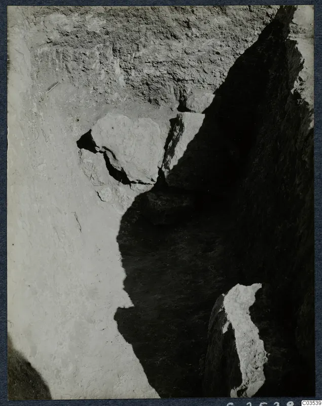 Excavation trench at Stylli with large stones set in a pale soil face