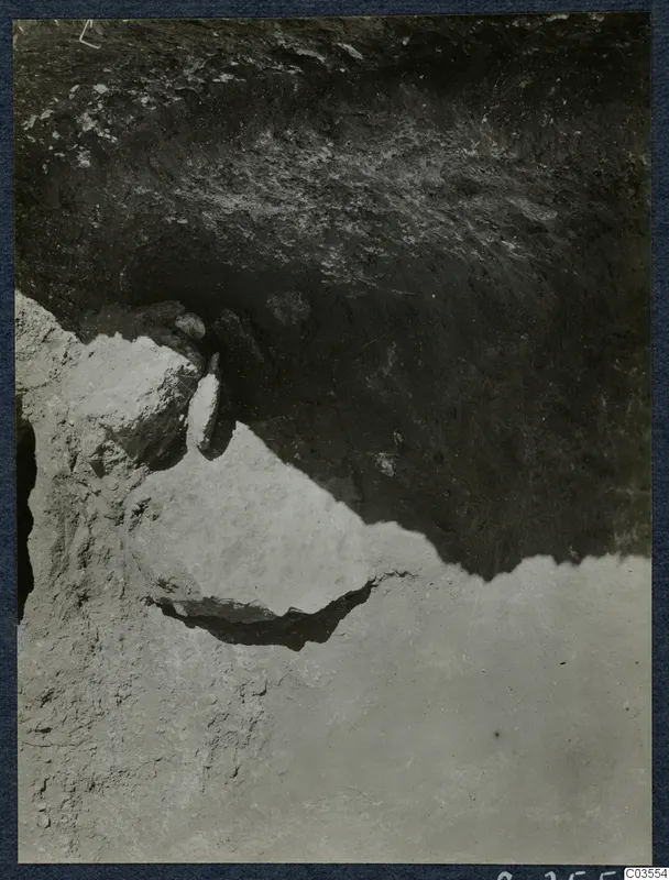 Close view of an excavated soil face at Stylli, with stones embedded in the section.