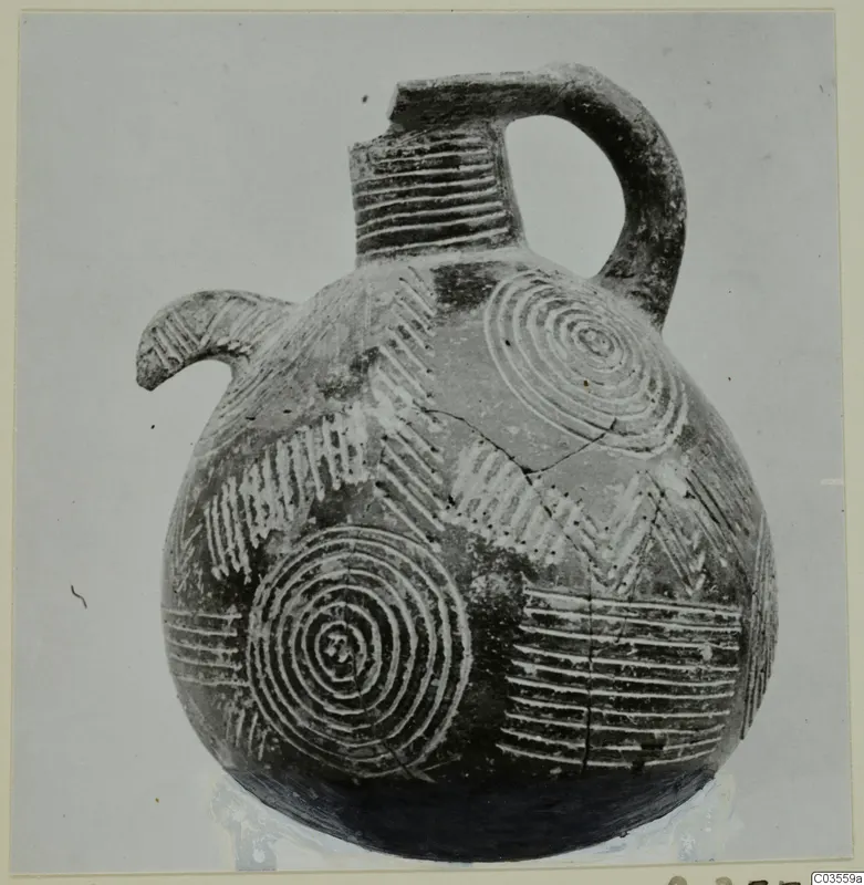 Pottery Red Polished II jug from Lapithos, with a beak spout, loop handle and pale concentric circles and chevrons